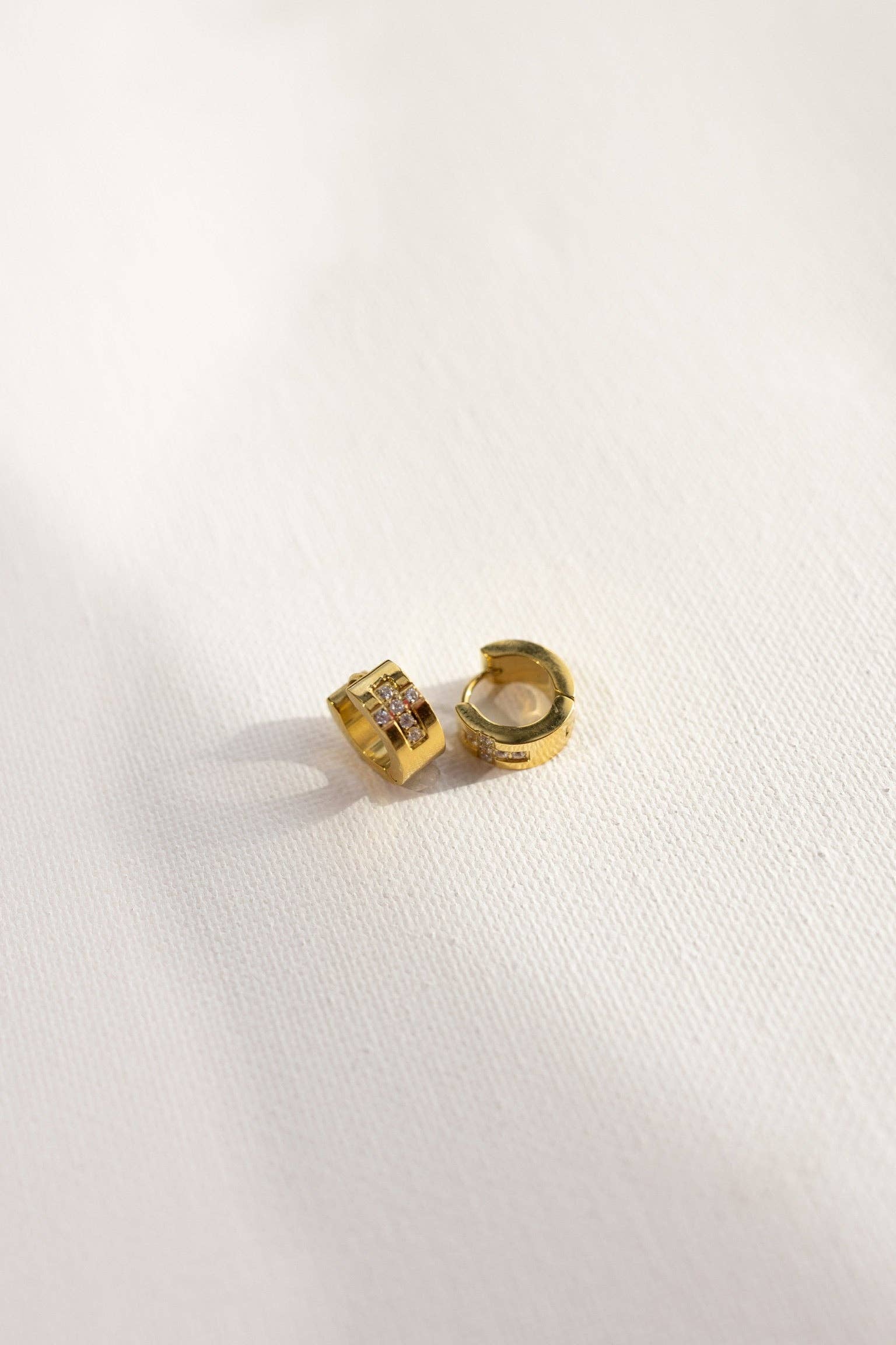 Ezri Crystal Cross Huggie Earrings